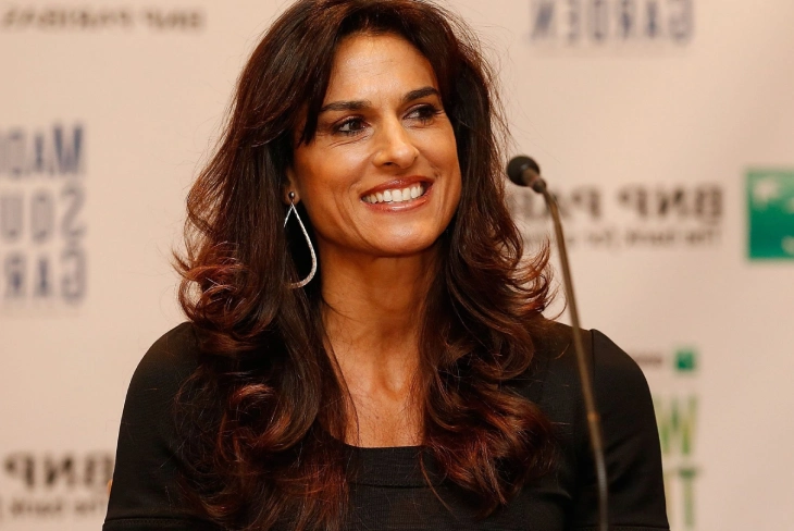 Gabriela Sabatini serving on tennis court, showcasing her iconic one-handed backhand technique.